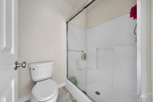 bathroom with toilet and walk in shower