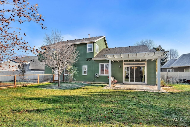 rear view of house featuring a yard, a pergola, and a patio area