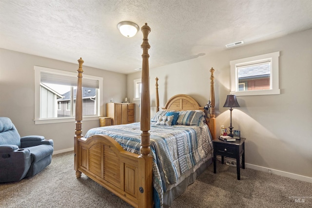 bedroom featuring carpet flooring, visible vents, baseboards, and a textured ceiling