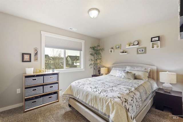 carpeted bedroom featuring visible vents and baseboards