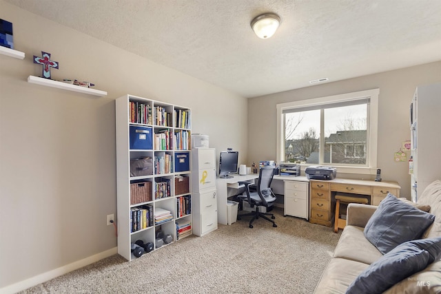 office featuring light carpet, baseboards, visible vents, and a textured ceiling