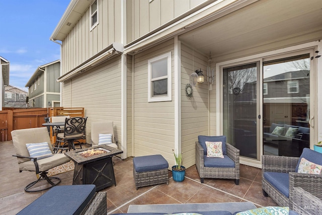 view of patio featuring an outdoor living space with a fire pit and fence