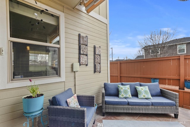 view of patio featuring outdoor lounge area and fence