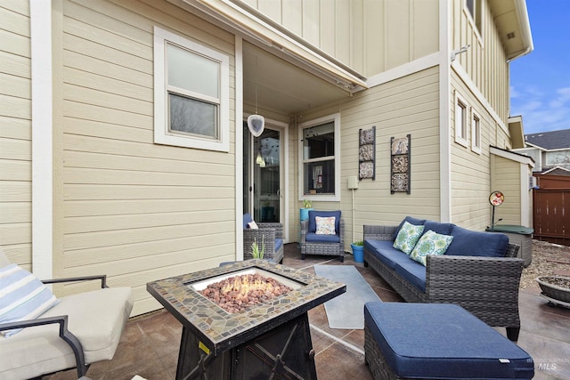 view of patio / terrace with an outdoor living space with a fire pit