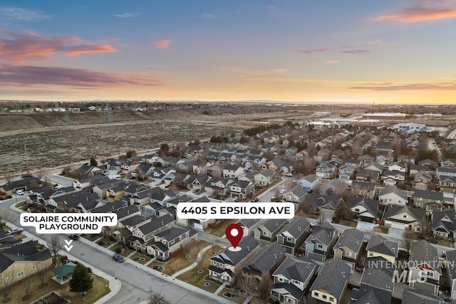 aerial view at dusk featuring a residential view