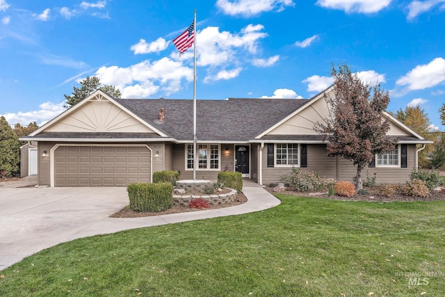 ranch-style house featuring an attached garage, driveway, and a front yard