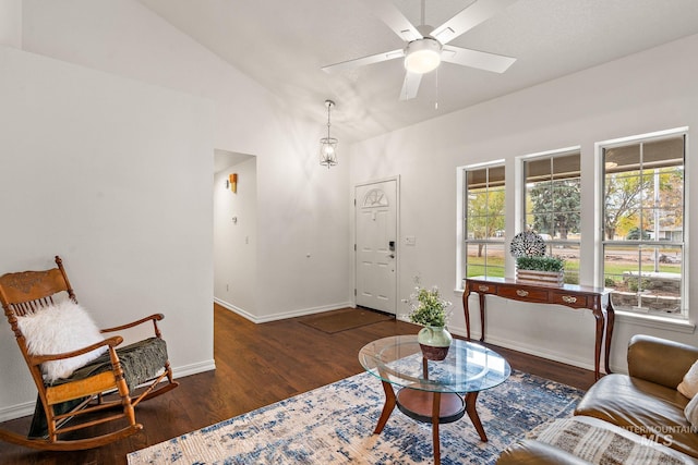 living room featuring vaulted ceiling, ceiling fan, wood finished floors, and baseboards