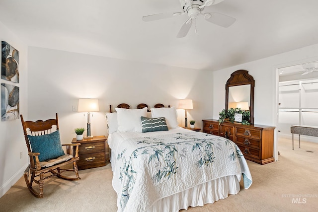 bedroom featuring baseboards, a ceiling fan, and light colored carpet