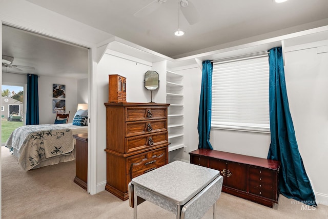 bedroom featuring a ceiling fan and light colored carpet