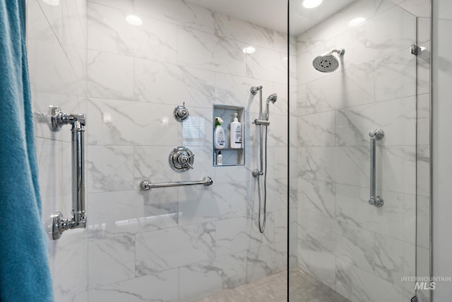 bathroom with a tile shower