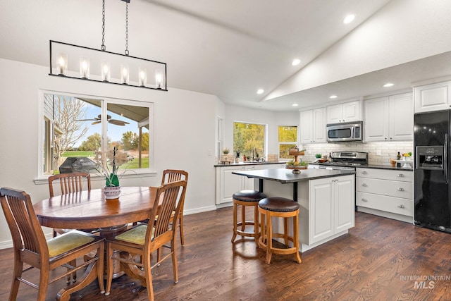 dining space with vaulted ceiling, dark wood-style flooring, a ceiling fan, and recessed lighting