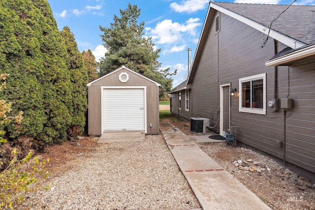 view of home's exterior featuring cooling unit and an outdoor structure