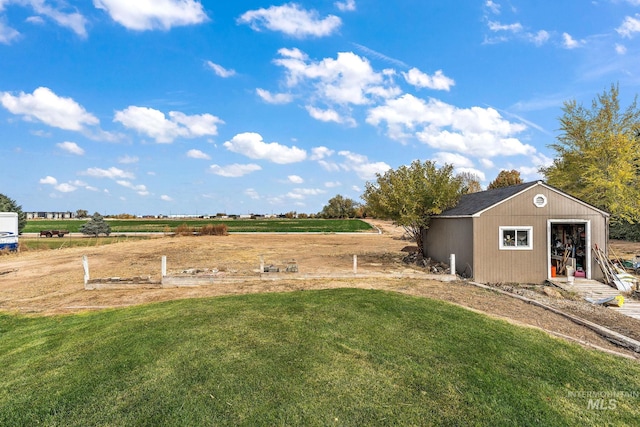 view of yard featuring a rural view and an outdoor structure