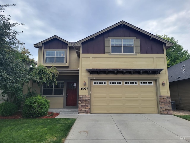 craftsman-style home featuring cooling unit, driveway, stone siding, a garage, and board and batten siding