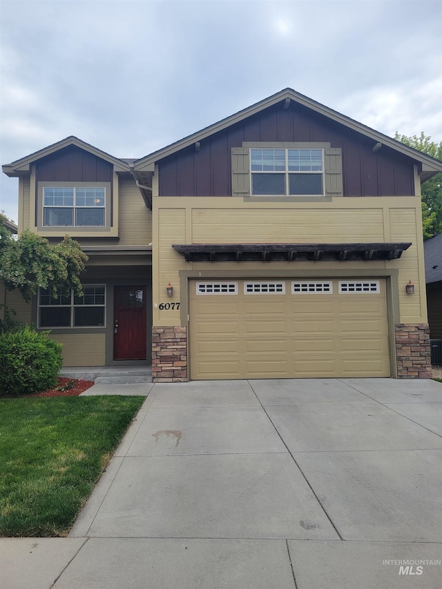 craftsman inspired home with board and batten siding, a garage, and concrete driveway