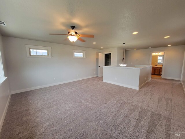 unfurnished living room with baseboards, recessed lighting, ceiling fan, and light colored carpet