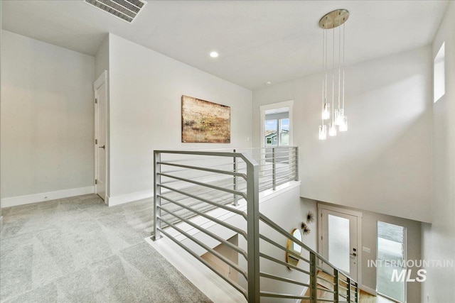 stairway with recessed lighting, baseboards, visible vents, and carpet floors