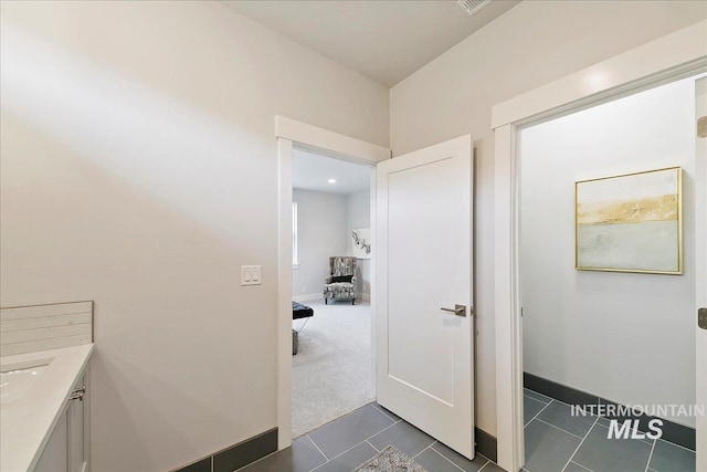 bathroom with vanity, tile patterned floors, and baseboards