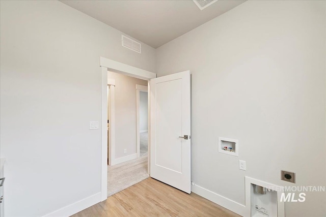 washroom featuring visible vents, baseboards, light wood-type flooring, washer hookup, and hookup for an electric dryer