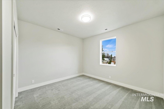 unfurnished bedroom featuring carpet flooring, baseboards, and visible vents