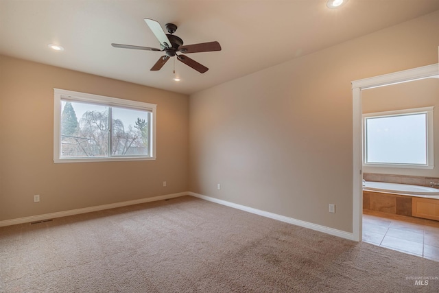 empty room with light colored carpet and ceiling fan