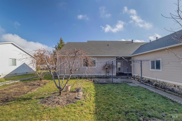 rear view of property featuring a yard and a patio area