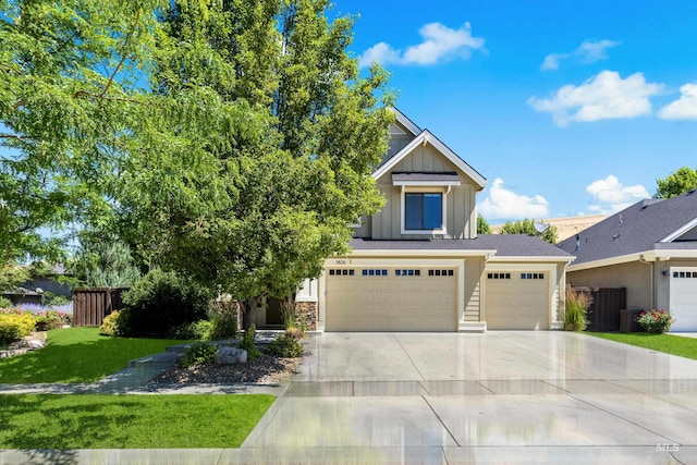 5826 E Playwright St, Boise, ID 83716 - view of front of property featuring board and batten siding, concrete driveway, a garage, and stone siding
