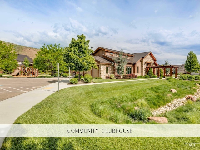 5826 E Playwright St, Boise, ID 83716 - view of front facade with stone siding, a standing seam roof, a front yard, and a metal roof