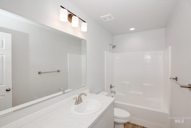 full bathroom featuring shower / washtub combination, vanity, and toilet