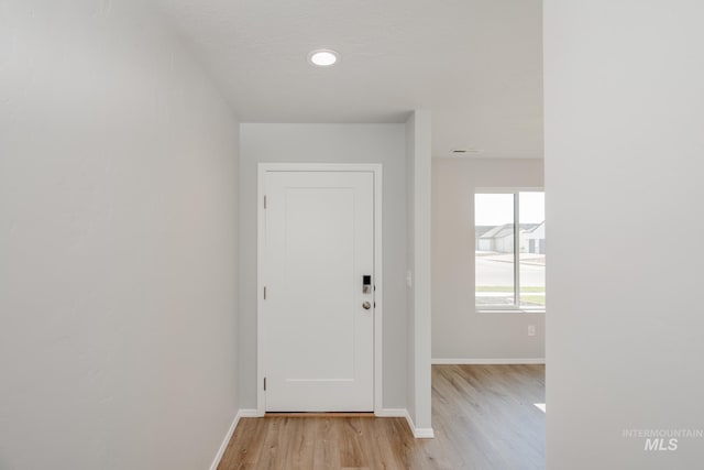 interior space featuring a textured ceiling and light hardwood / wood-style flooring