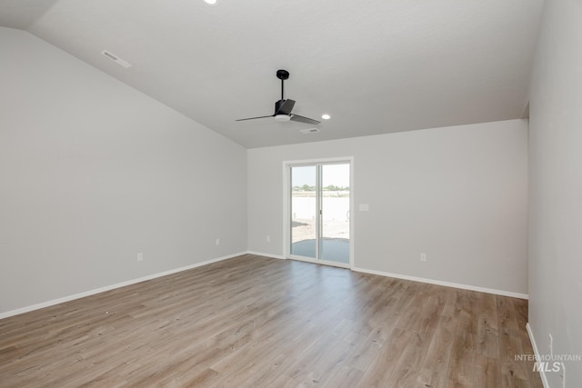 empty room featuring ceiling fan, lofted ceiling, and light wood-type flooring