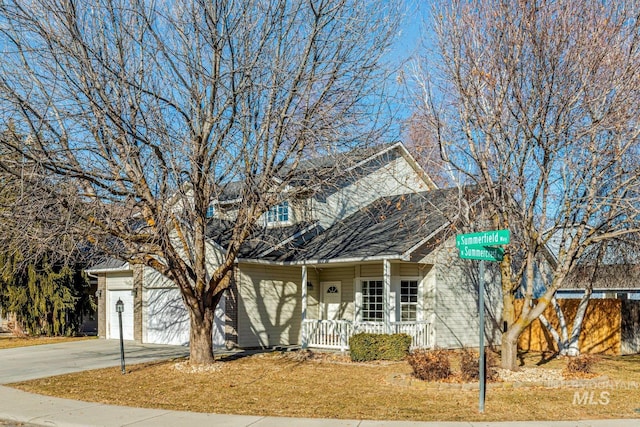 view of front of home featuring a porch and a garage