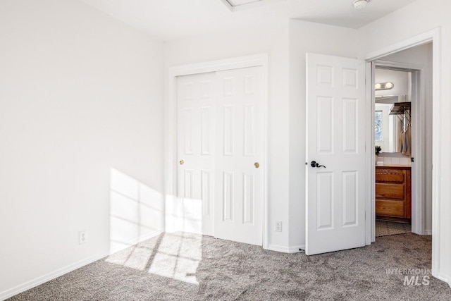 unfurnished bedroom featuring carpet flooring and a closet