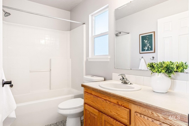 full bathroom featuring vanity, bathtub / shower combination, and toilet