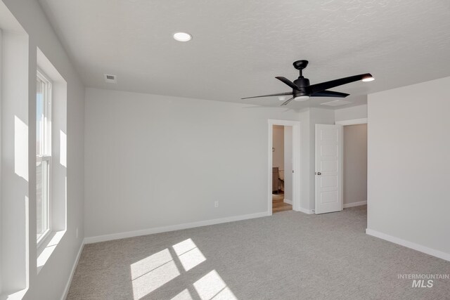 4353 N Magical Creek Ave, Meridian, ID 83646 - carpeted spare room with a textured ceiling, visible vents, baseboards, recessed lighting, and a ceiling fan