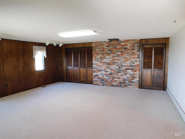 24405 Red Top, Wilder, ID 83676 - empty room with a textured ceiling, wooden walls, light carpet, and brick wall