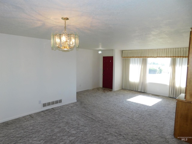 24405 Red Top, Wilder, ID 83676 - carpeted spare room featuring a chandelier