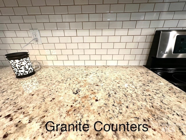 interior details with light stone counters and decorative backsplash