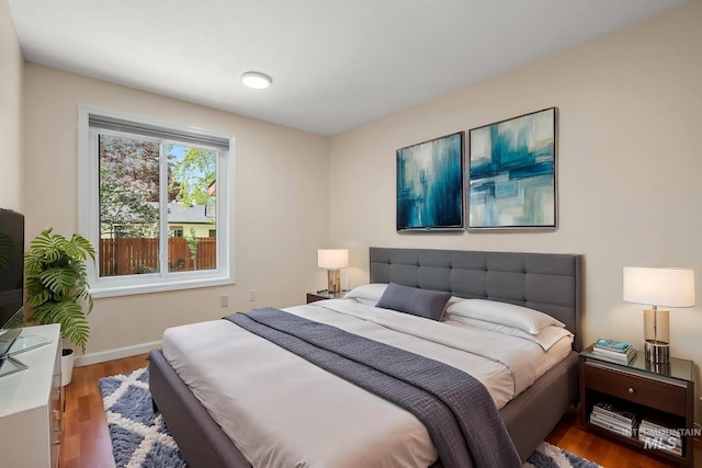 bedroom featuring baseboards and wood finished floors