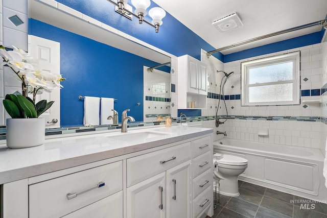 bathroom with vanity, toilet, and  shower combination