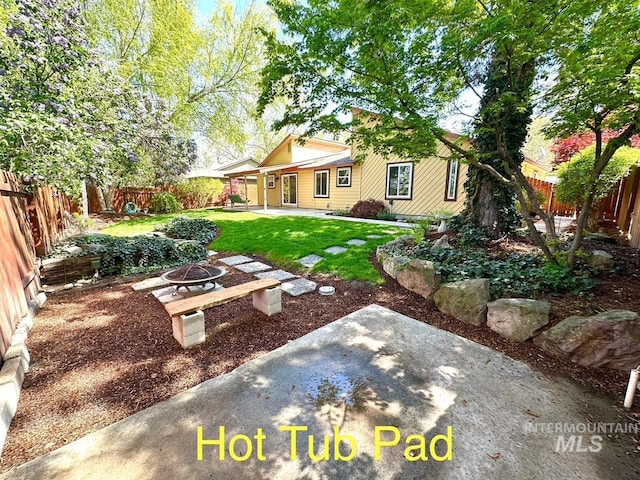 view of yard featuring a fenced backyard, a patio area, and an outdoor fire pit