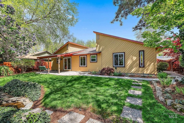 back of house with a lawn, a patio area, and fence