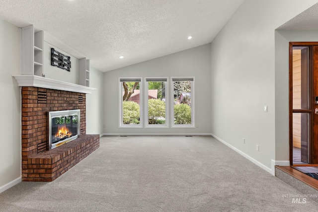 unfurnished living room featuring a fireplace, carpet flooring, and a textured ceiling