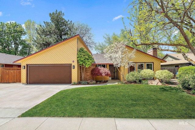 mid-century inspired home featuring driveway, a chimney, a front yard, fence, and an attached garage