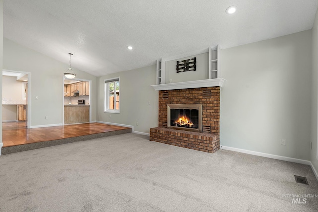 unfurnished living room featuring a fireplace, carpet floors, recessed lighting, baseboards, and visible vents