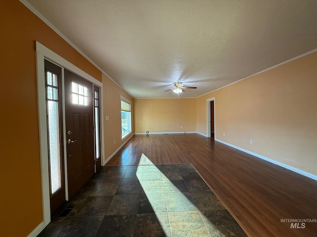 entrance foyer featuring ornamental molding, dark wood-type flooring, and baseboards