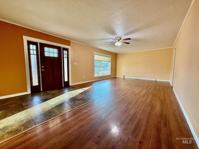 entrance foyer with baseboards, crown molding, a textured ceiling, and hardwood / wood-style floors