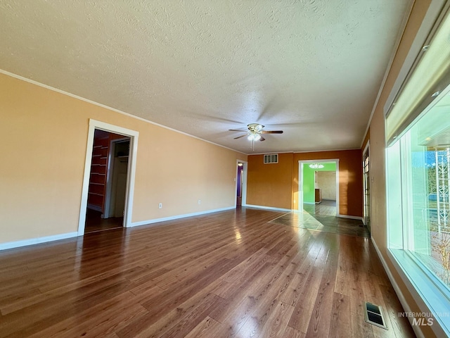 spare room featuring ornamental molding, wood finished floors, and visible vents