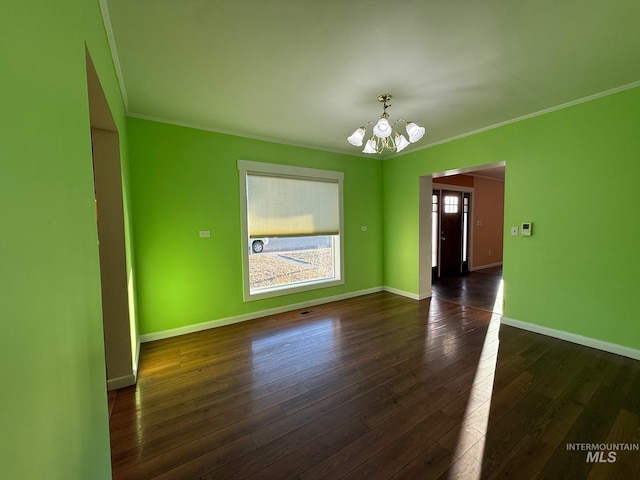 interior space featuring baseboards, ornamental molding, dark wood-style flooring, and an inviting chandelier