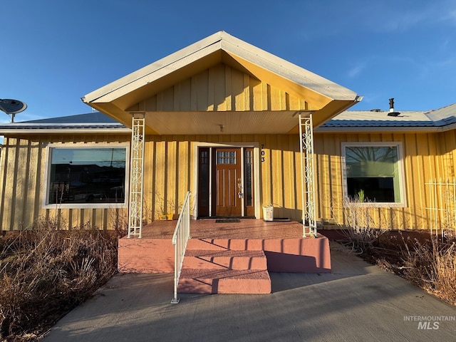 view of exterior entry featuring board and batten siding